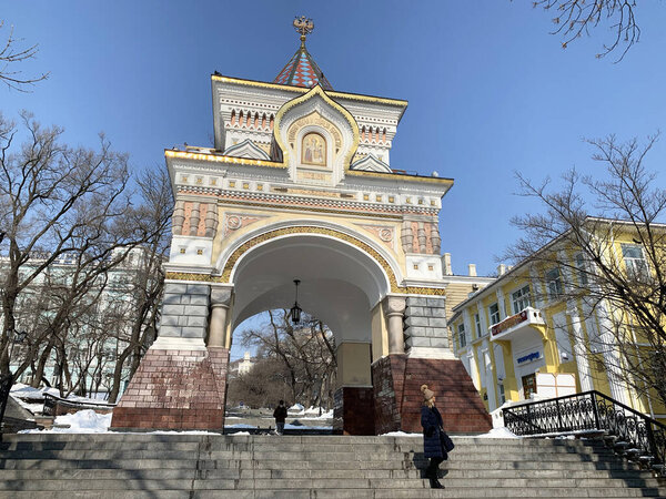 Vladivostok, Russia, March, 11,2020. People walking near Triumphal (Nicholas) arch of the Tsarevich. Vladivostok, winter