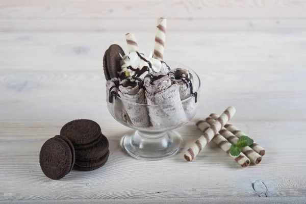 Roll of ice cream with crushed chocolate cookies. Fresh fried ic