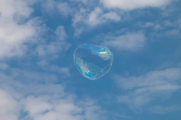 A soap bubble floating in the sky.