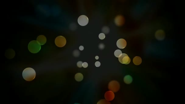 Abstract colorful transparent circles appear in the center on a dark background and move to the edges of the screen, change focus, color and disappear. Loop animation — Stock Video