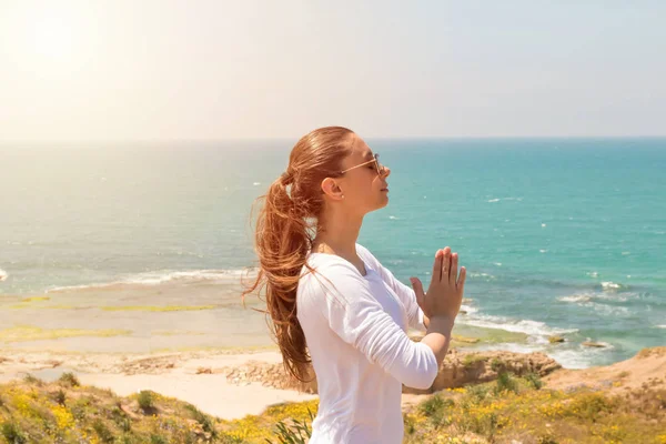  Bir genç kadın yoga deniz sahilde