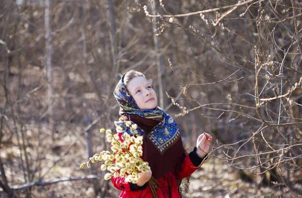 Russian girl in national scarf with branches of a willow in his hands — Stock Photo, Image