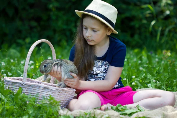 Girl is holding a little rabbit — Stock Photo, Image