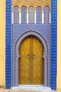 Entrance door with mosiac and brass door at the Royal palace in  clipart