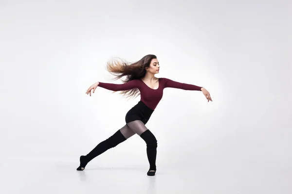 Νεαρή γυναίκα χορεύτρια σε βυσσινί μαγιό ποζάρει — Φωτογραφία Αρχείου