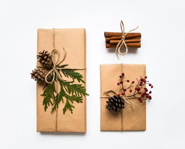 Gift boxes in craft paper on white background. Christmas or other holiday concept, top view, flat lay Stock Photo