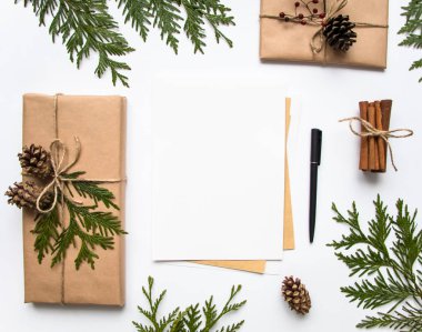 Hediye kutuları Kraft kağıt ve beyaz arka plan üzerinde bir mektup. Noel veya diğer tatil kavramı, üstten görünüm, düz yatıyordu