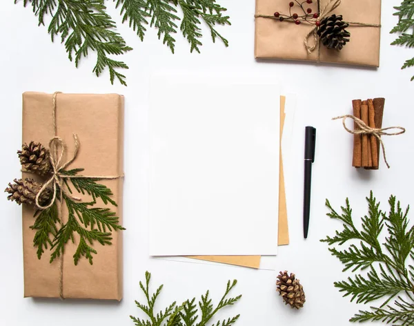 礼品盒牛皮纸和白色背景上的一封信。圣诞节或其他假日概念，顶视图，平躺 图库图片