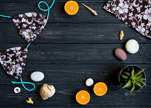 Holiday elements: swimsuit, stones, seashells, fruits. Travel photo, flat lay, top view — Stock Photo, Image