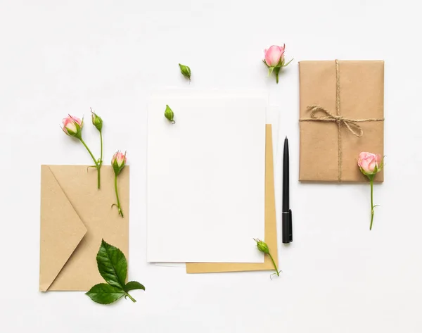 편지, 봉투 및 백색 배경에 선물입니다. 초대 카드, 또는 분홍색 장미와 연애 편지. 휴일 개념, 평면도, 평면 위치 — 스톡 사진