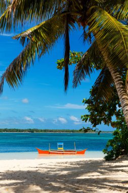 Tropical Guyam Island with traditional fishing boats, Siargao, Philippines clipart