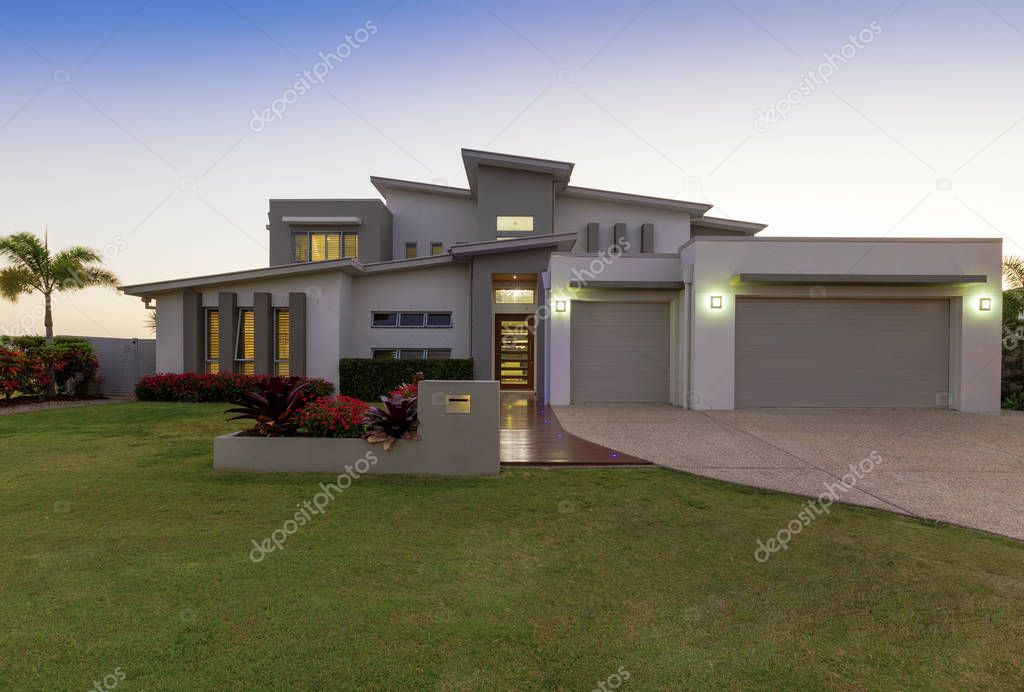 Modern multilevel house exterior at dusk