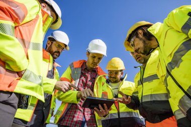Engineers and workers assesing wastewater plant