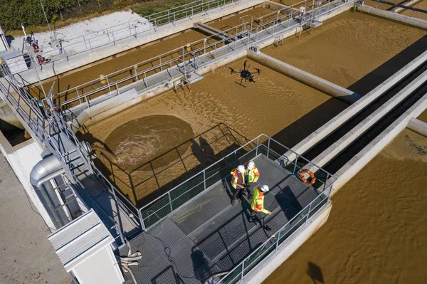 Engineers assesing waste treatment plant with drone — Stok fotoğraf