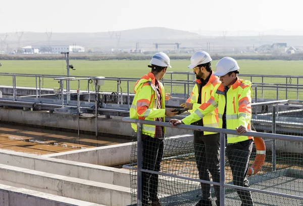 Engineers assesing wastewater plant — 스톡 사진