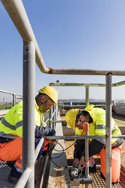 Workers on site of wastewater treatment plant — 스톡 사진