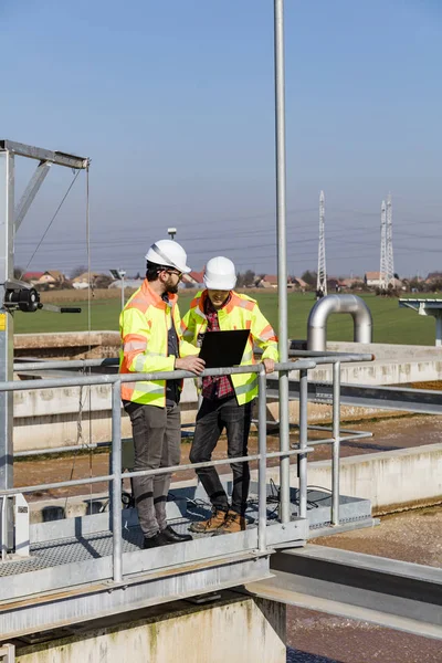 Engineers working on water treatment plant — 스톡 사진