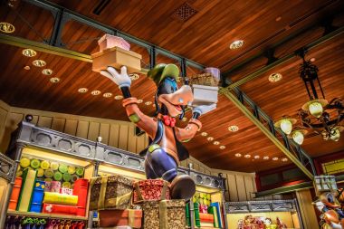 HONG KONG DISNEYLAND - MAY 2015: Goofy carrying gifts in the store clipart