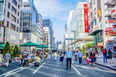 TOKYO, JAPAN: People spending their time visiting Ginza street, a very popular shopping area of Tokyo, during weekend clipart
