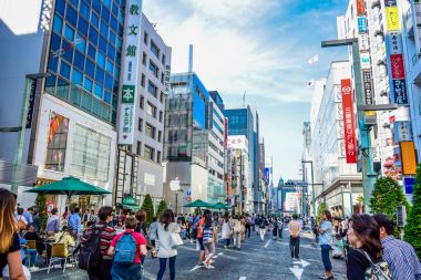 TOKYO, JAPAN: People spending their time visiting Ginza street, a very popular shopping area of Tokyo, during weekend clipart