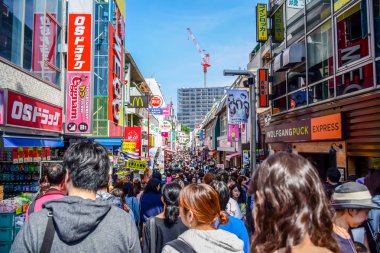 TOKYO, JAPAN: People are shopping at Takeshita street, a famous shopping street lined with fashion boutiques, cafes and restaurants in Harajuku in Tokyo, Japan clipart