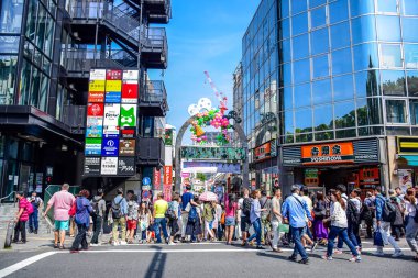 TOKYO, JAPAN: People are shopping at Takeshita street, a famous shopping street lined with fashion boutiques, cafes and restaurants in Harajuku in Tokyo, Japan clipart