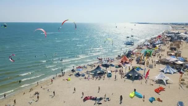 Aerial view of kitesurfing extreme sport with the wind freestyle. Beautiful top view of nice beach. Lots of kites — Stock Video