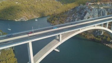Köprü ve Denizi Adaları çevresinde hava panorama görünüm. Güzel manzara ile arasında köprü mavi denizi ile çevrili. Güneşli bir gün Krka nehirde Hırvatistan üzerindeki trafik köprüsüyle otobanı.