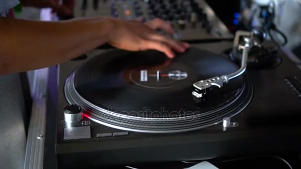Mix and scratch, hands of a DJ on vinyl and mixer knobs. Slow motion 120 fps. Shooting with gimbal. Sunset. — Stock Video