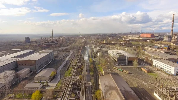 Aerial view of industrial steel plant. Aerial sleel factory. Flying over smoke steel plant pipes. Environmental pollution. Smoke.