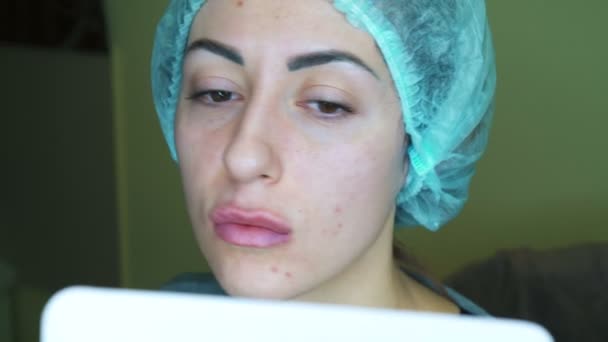 Beautician make injection plastic lips. Young woman on lip Augmentation in a clinic — Stock Video