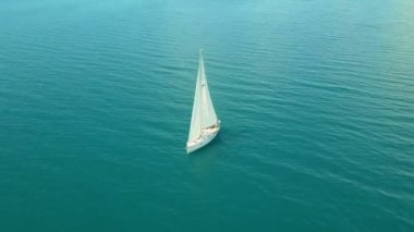 Açık denizde yat gezintisi. Yelkenli. İHA 'dan gelen yat. Yat videosu. Yukardan yat. İHA 'dan yelkenliye. Yelkenli videosu. Rüzgarlı bir günde yat. Yat. Yelkenli..
