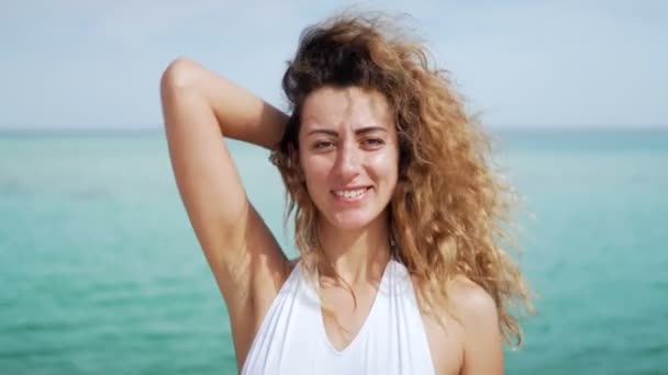 아름 다운 젊은 여자의 초상화를 닫습니다. 열 대 해변 슬로우 모션에 바람에 날 려. — 비디오