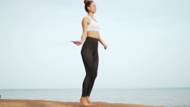Meisje doet sporten op het strand — Stockvideo