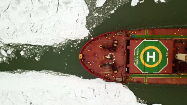 Aerial view. The ship sails through the sea ice in the winter, close-up — Stock Video