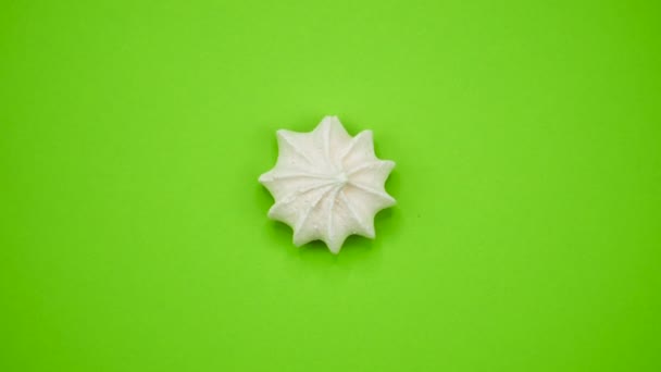 Bright and colorful marshmallow close-up macro shot on a green background. Rotating Top view. — Stock Video