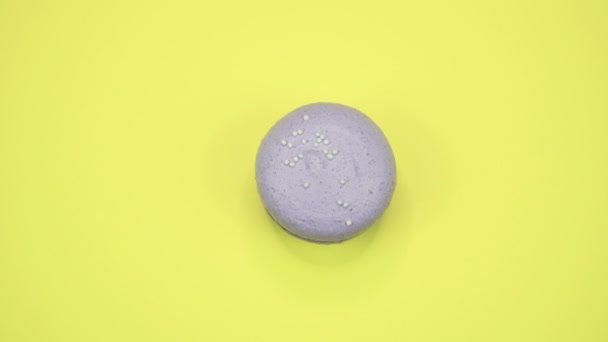 ROTATION: A Colorful Macaroons are rotating on a yellow background — Stock Video