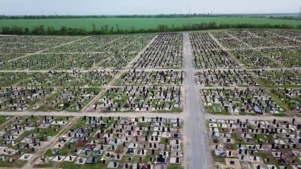 An aerial over a vast cemetery of headstones honors veterans — Stock Video