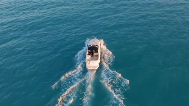 Вид з повітря. Моторний човен, що пливе у блакитному морі. Розкішна яхта готується на глибокій воді. Подорожі відпочинок на білій яхті . — стокове відео
