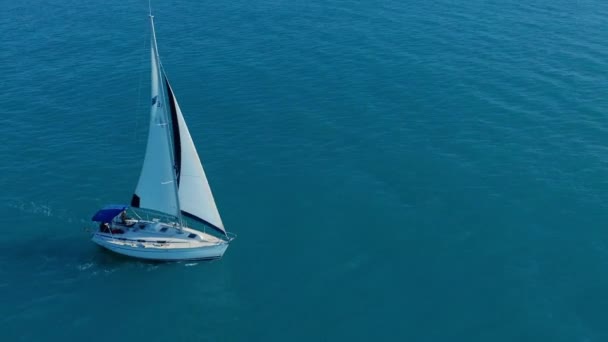 Aerial view. Yacht sailing on opened sea. Sailing boat. Yacht from above. Yachting at windy day. — Stock Video