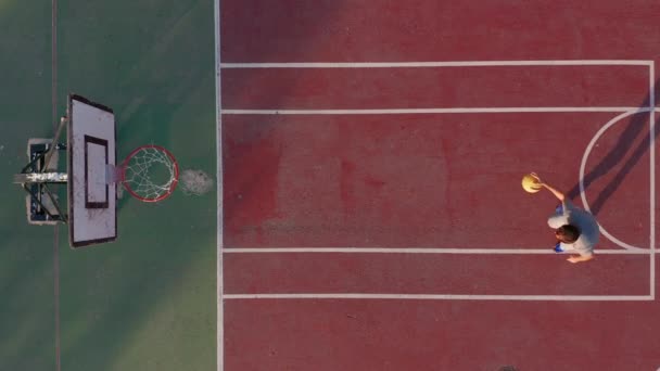 Vista aerea. Uomo che gioca a basket in campo . — Video Stock