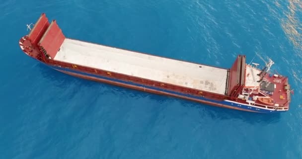 Aerial view. Red deck cargo ship sailing on open sea. — 비디오