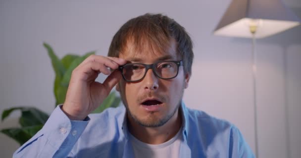 Um homem de surpresa atira em óculos e olha para a câmera de surpresa. Empresário chocado . — Vídeo de Stock