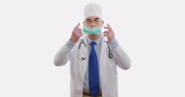 A man doctor puts on a face shield. The epidemic situation. Coronavirus or COVID19. Isolated on white. — Stock Video