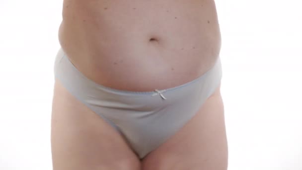 The Woman in underwear shakes belly fat. Closeup. — Stock Video