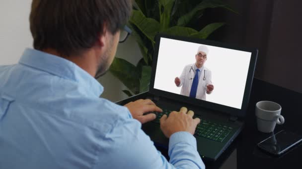 Le médecin principal porte un manteau médical blanc, un stéthoscope, un casque fait un appel vidéo distant. Vieux médecin adulte parle à la caméra de consultation patient en ligne dans le chat web. Concept de télémédecine . — Video