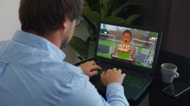 İnternet üzerinden bir iş adamının doğum günü kutlu olsun. Web kamerasında gösterilen mumlu pasta. Ev karantinası, sosyal uzaklık, kişisel izolasyon..