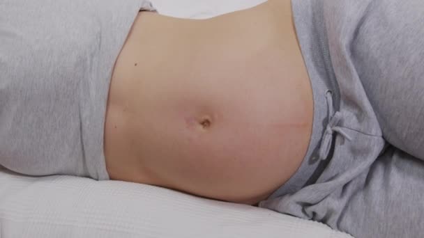 Close up pregnant woman playing with baby kicking from inside the belly. — Stock Video