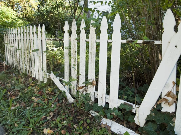 Weißer Lattenzaun fällt auseinander — Stockfoto