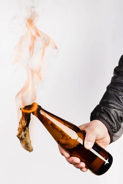 Glass bottle, the so-called Molotov cocktail in the hand of the — Stock Photo, Image